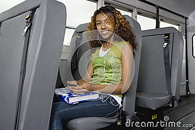 Teenage Girl Listening To MP3 Player On Bus Stock Photo