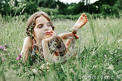 Teenage girl with long hair and bare feet in the grass Stock Photo