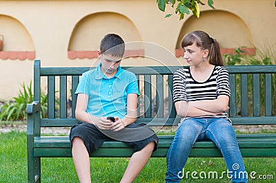 Teenage girl looking with love at indifferent teenage boy Stock Photo