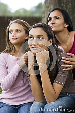 Teenage girl with mother and younger sister Stock Photo