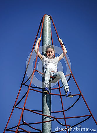 Teenage girl playing on child playground Stock Photo