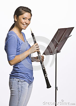 Teenage girl playing clarinet Stock Photo
