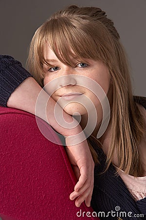 Teenage Girl Relaxing On Chaise Longue Stock Photo