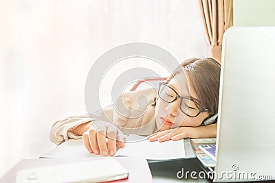 Teenage girl short hair sleep on desk after working Stock Photo