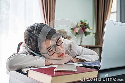 Teenage girl short hair sleep on desk after working Stock Photo