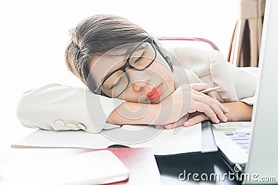 Teenage girl short hair sleep on desk after working Stock Photo