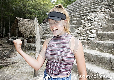 Teenage girl showing strength after climbing and descending the Nohoch Mul Pyramid Stock Photo