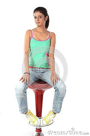 Teenage girl sitting on chair Stock Photo