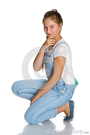 A teenage girl is sitting on the floor. Stock Photo