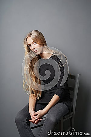 Teenage girl slouching on chair Stock Photo