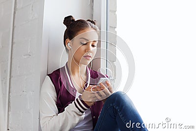 Teenage girl with smartphone and earphones Stock Photo