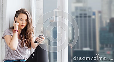 Teenage girl with smartphone and earphones Stock Photo