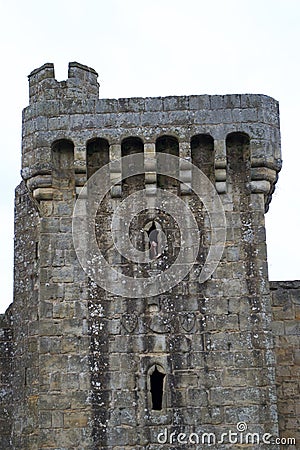 A teenage girl smiling from the window of a ruined ancient stone tower Stock Photo