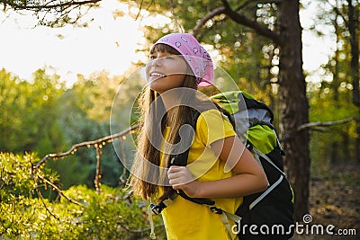 Girl traveler with backpack in hill forest. Adventure, travel, tourism concept Stock Photo