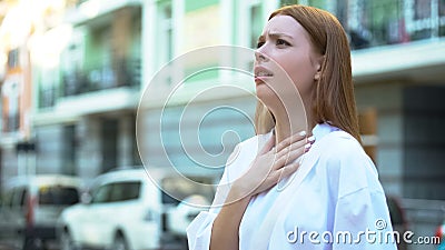 Teenage girl trying to inhale, contaminated air, big city air pollution concept Stock Photo