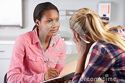 Teenage Girl Visits Doctor's Office Suffering With Depression Stock Photo