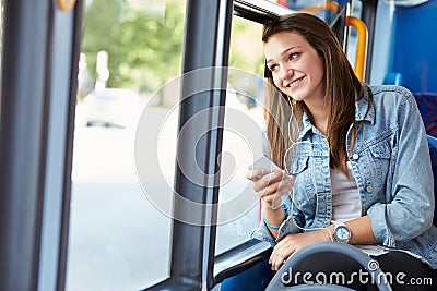 Teenage Girl Wearing Earphones Listening To Music On Bus Stock Photo