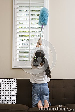 Teenage Girl Whisking At Window Stock Photo