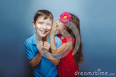 Teenage girl whispering in the ear of teen boys on Stock Photo