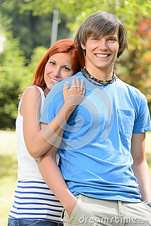 Teenage girlfriend embracing her boyfriend in park Stock Photo