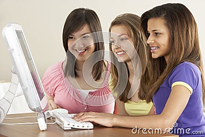 Teenage Girlfriends on Computer at Home Stock Photo
