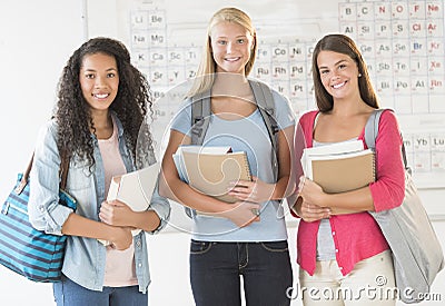 Teenage Girls With Backpacks And Books In Chemistry Class Stock Photo