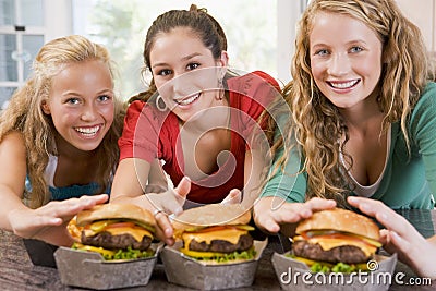 Teenage Girls Eating Burgers Stock Photo