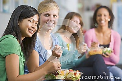 Teenage girls enjoying healthy lunches together Stock Photo