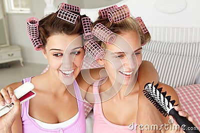 Teenage girls with hair in curlers Stock Photo