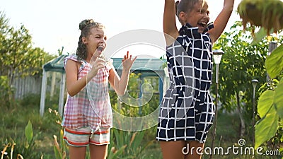 Teenage girls are jumping in the sun under streams of water. Happy holiday concept, summer vacation stock video Teenage girls are jumping in the sun under streams of water. Happy holiday concept, summer vacation stock video