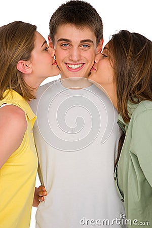 Teenage girls kissing teenage boy Stock Photo