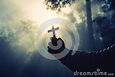 Teenage girls pray with a cross in a sunny nature. The girl sat in the green forest with sunlight. Stock Photo