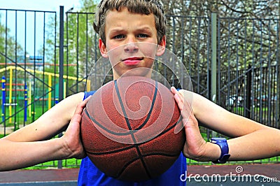 Teenage playing basketball on the court Stock Photo