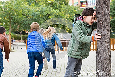 Teenage playing hide-and-go-seek in the playground Stock Photo