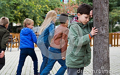 Teenage playing hide-and-go-seek in the playground Stock Photo