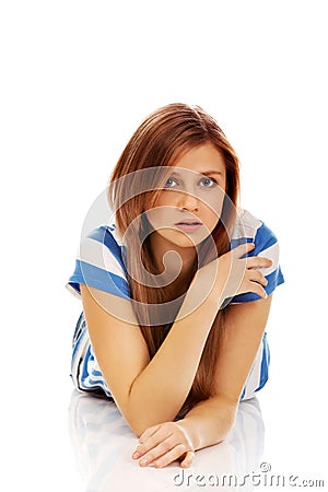 Teenage sad woman lies on the floor Stock Photo