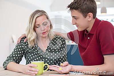 Teenage Son Helping Parent Suffering With Mental Health Problems Stock Photo
