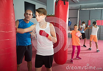 Teenage sportsman at boxing workout Stock Photo