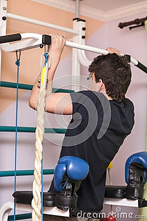 A teenage sportsman is pushed up at home on a Swedish wall Stock Photo