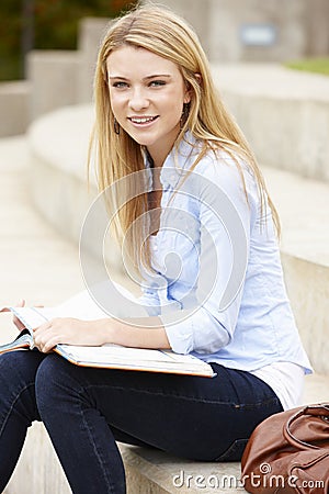 Teenage student working outdoors Stock Photo