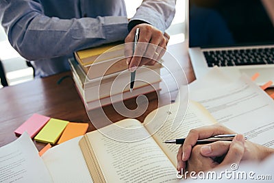 Teenage student works on homework in his room and writing in notebook Stock Photo