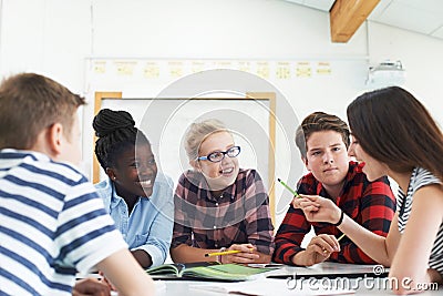 Group Of Teenage Students Collaborating On Project In Classroom Stock Photo