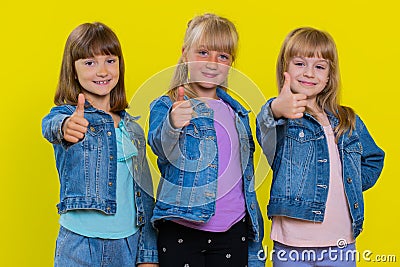 Teenage three girls raises thumbs up agrees, gives positive reply, like gesture, good feedback Stock Photo