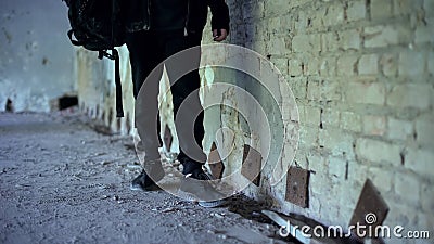 Teenager in abandoned house, comfortable shoes for extreme adventures closeup Stock Photo