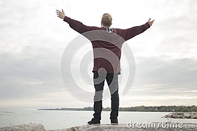 Teenager with arms in air Stock Photo