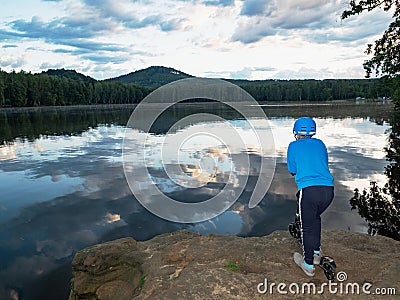 Teenager boy in a blue helmet stay at push scooter Stock Photo