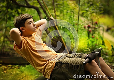 Teenager boy do push up pilates abdomen exercises on portable trainer Stock Photo