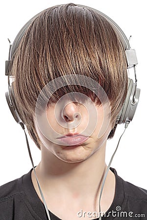 Teenager boy with hair over his eyes and headphones Stock Photo