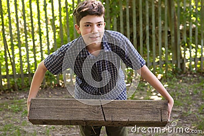 Teenager boy with heavy weight log Stock Photo