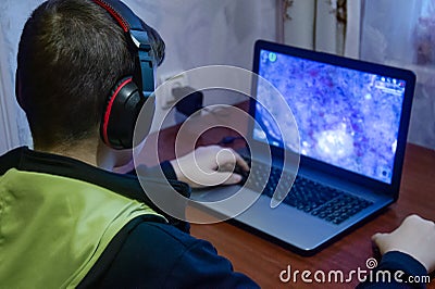 Teen plays computer games, The boy sits at home computer. Reading, boys Stock Photo
